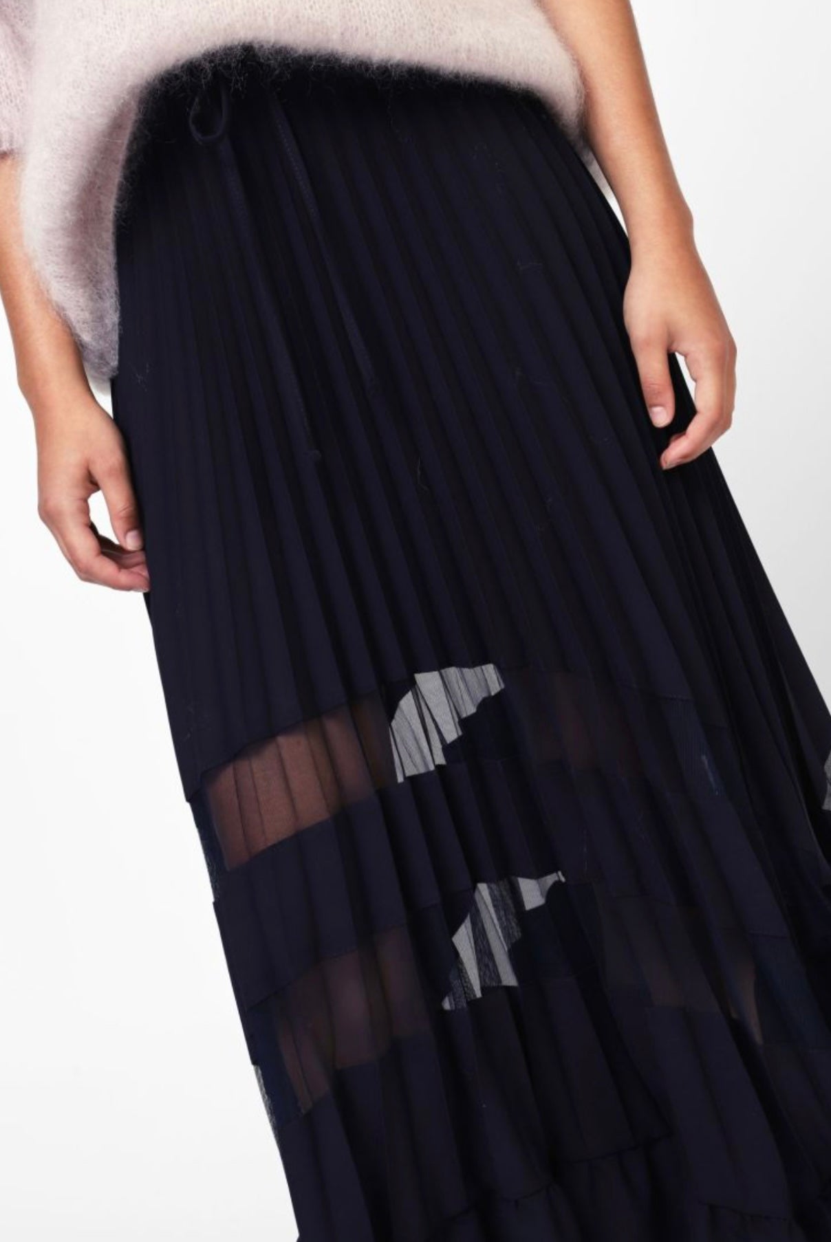 Pleated black skirt with translucent details